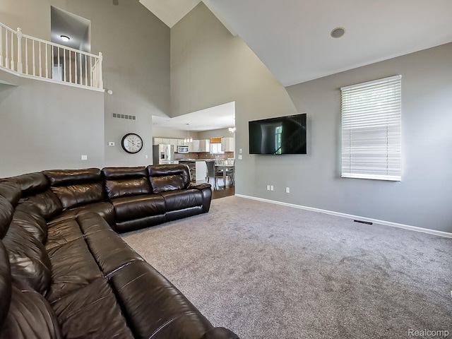 8595 Eastway Dr, White Lake, MI 48386 - living area featuring carpet flooring and high vaulted ceiling