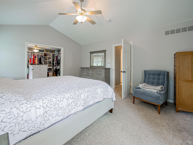 8595 Eastway Dr, White Lake, MI 48386 - bedroom featuring vaulted ceiling, a walk in closet, light colored carpet, a closet, and a ceiling fan