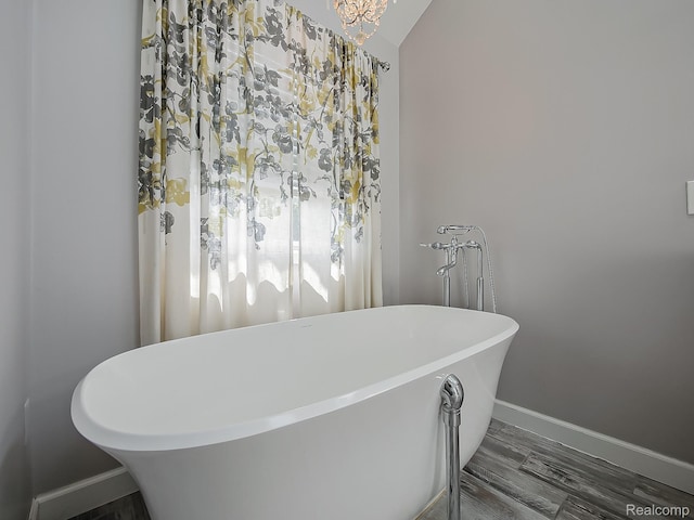 8595 Eastway Dr, White Lake, MI 48386 - bathroom featuring baseboards and a freestanding bath