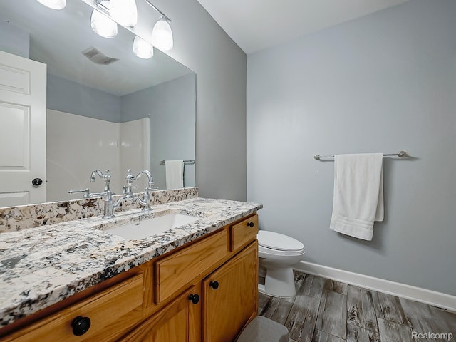 8595 Eastway Dr, White Lake, MI 48386 - bathroom featuring wood finished floors, vanity, and a shower