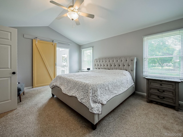 8595 Eastway Dr, White Lake, MI 48386 - bedroom with vaulted ceiling, a barn door, light colored carpet, and ceiling fan