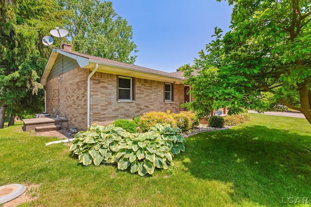 13936 Allen Rd, Clinton, MI 49236 - view of side of property with a chimney, a lawn, and brick siding