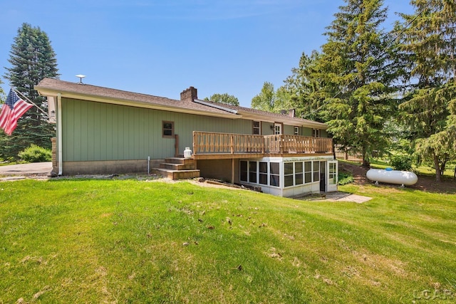 13936 Allen Rd, Clinton, MI 49236 - rear view of house with a deck, a sunroom, a chimney, and a lawn