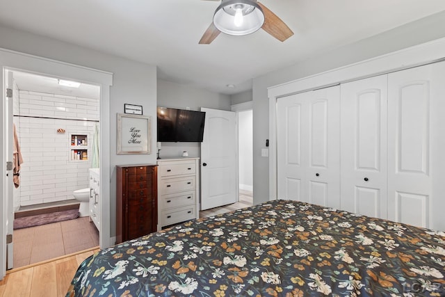 13936 Allen Rd, Clinton, MI 49236 - bedroom with a closet, connected bathroom, ceiling fan, and wood finished floors