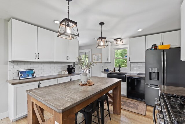 13936 Allen Rd, Clinton, MI 49236 - kitchen featuring dishwasher, white cabinets, light wood finished floors, decorative backsplash, and recessed lighting