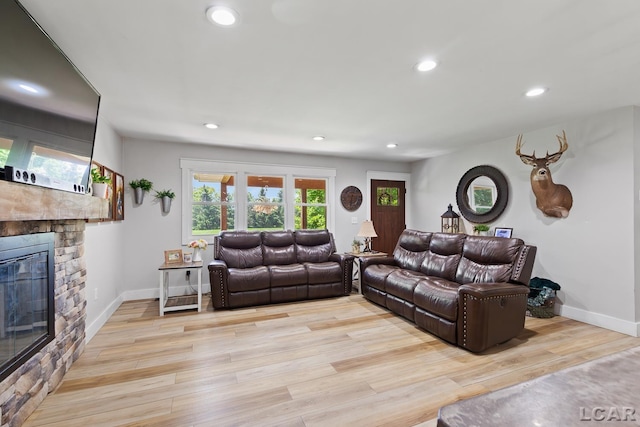 13936 Allen Rd, Clinton, MI 49236 - living area with a stone fireplace, light wood-style flooring, and recessed lighting