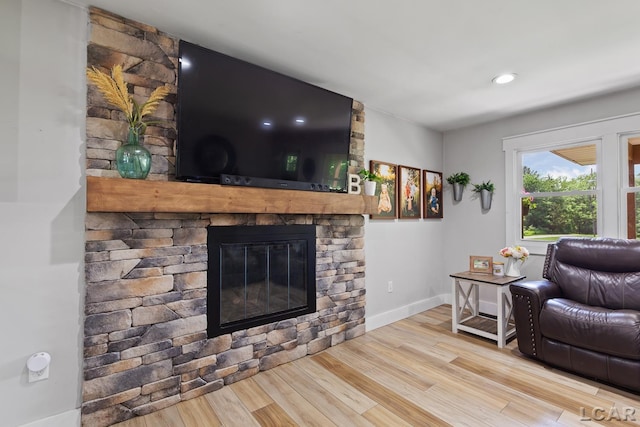 13936 Allen Rd, Clinton, MI 49236 - living area with a stone fireplace and wood finished floors
