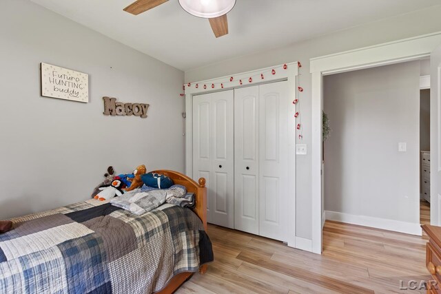 13936 Allen Rd, Clinton, MI 49236 - bedroom with a closet, light wood-style floors, and ceiling fan