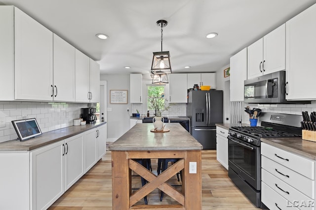 13936 Allen Rd, Clinton, MI 49236 - kitchen with appliances with stainless steel finishes, backsplash, light wood finished floors, recessed lighting, and white cabinets
