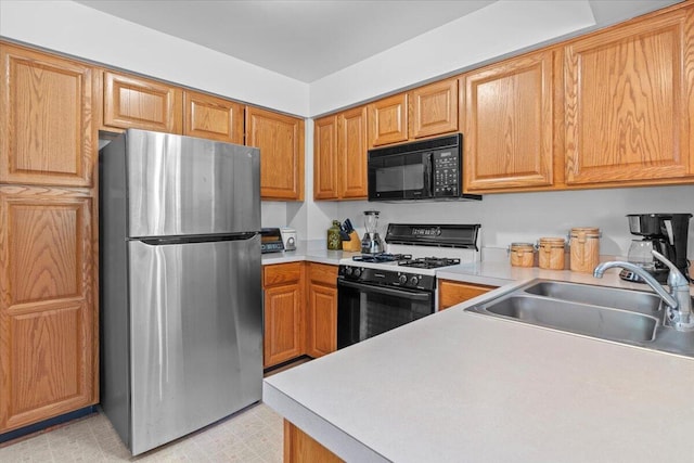 3059 Ailsa Craig, Ann Arbor, MI 48108 - kitchen featuring freestanding refrigerator, black microwave, gas stove, and light countertops