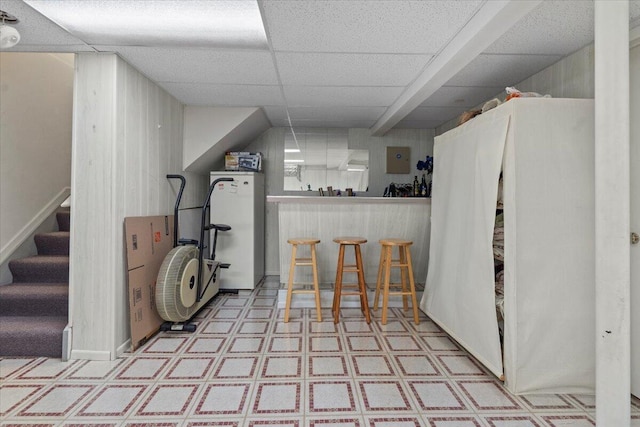 3059 Ailsa Craig, Ann Arbor, MI 48108 - kitchen featuring tile patterned floors, wood walls, electric panel, a paneled ceiling, and freestanding refrigerator