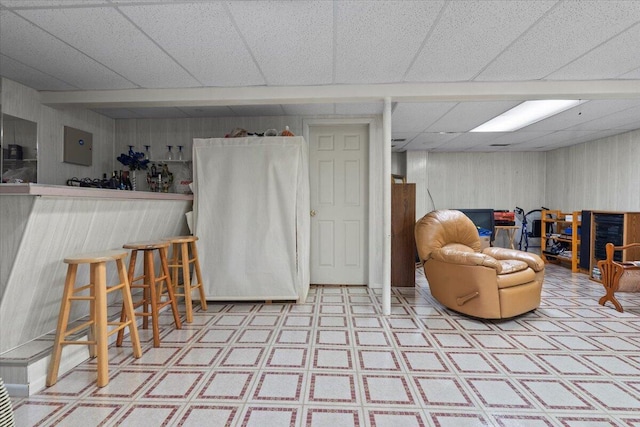 3059 Ailsa Craig, Ann Arbor, MI 48108 - sitting room featuring tile patterned floors, wood walls, and a drop ceiling