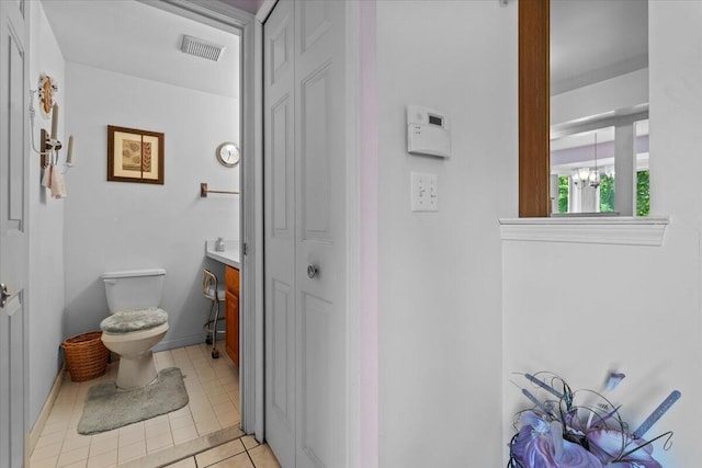 3059 Ailsa Craig, Ann Arbor, MI 48108 - bathroom featuring a closet, tile patterned floors, a chandelier, and vanity