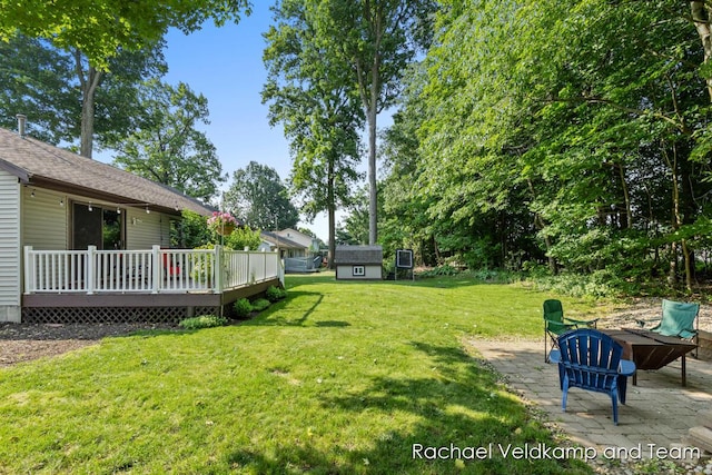 1579 Geddes Ave NW, Grand Rapids, MI 49534 - view of green lawn featuring a patio, a wooden deck, and an outbuilding