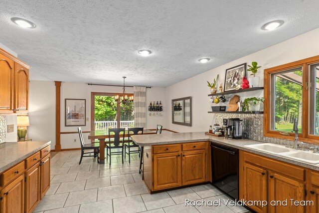 1579 Geddes Ave NW, Grand Rapids, MI 49534 - kitchen with black dishwasher, brown cabinets, a peninsula, a textured ceiling, and recessed lighting