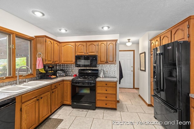 1579 Geddes Ave NW, Grand Rapids, MI 49534 - kitchen with black appliances, decorative backsplash, brown cabinetry, light countertops, and a textured ceiling