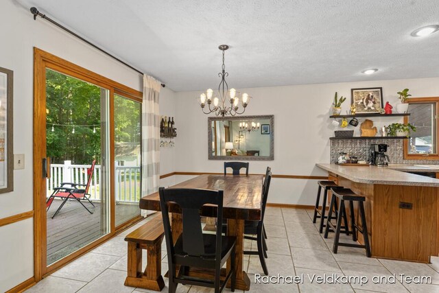 1579 Geddes Ave NW, Grand Rapids, MI 49534 - dining area featuring light tile patterned floors, a chandelier, a textured ceiling, and recessed lighting