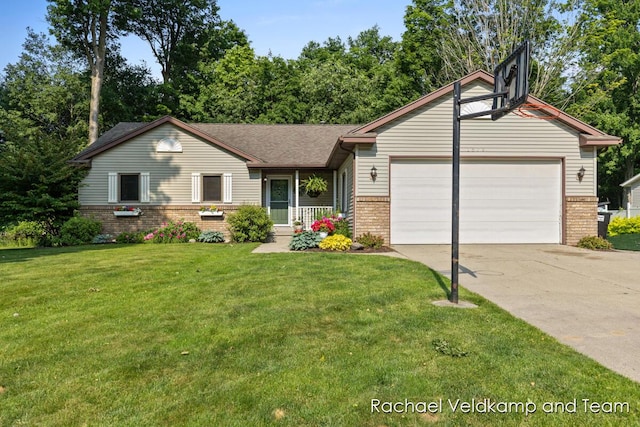 1579 Geddes Ave NW, Grand Rapids, MI 49534 - view of front of house with brick siding, a garage, driveway, and a front yard