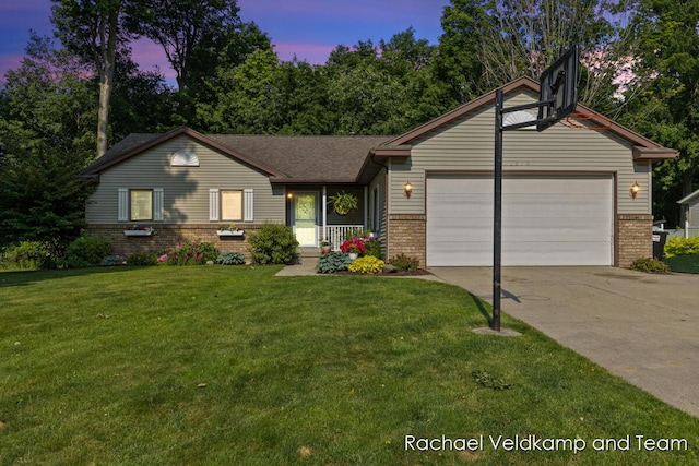 1579 Geddes Ave NW, Grand Rapids, MI 49534 - view of front of house featuring brick siding, an attached garage, driveway, and a lawn