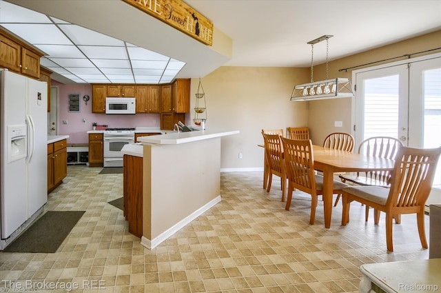 1484 E Baldwin Rd, Grand Blanc, MI 48439 - kitchen with white appliances, brown cabinets, light countertops, and a peninsula