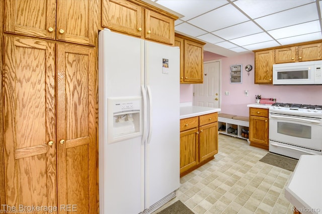 1484 E Baldwin Rd, Grand Blanc, MI 48439 - kitchen featuring white appliances, light countertops, light floors, a drop ceiling, and brown cabinets