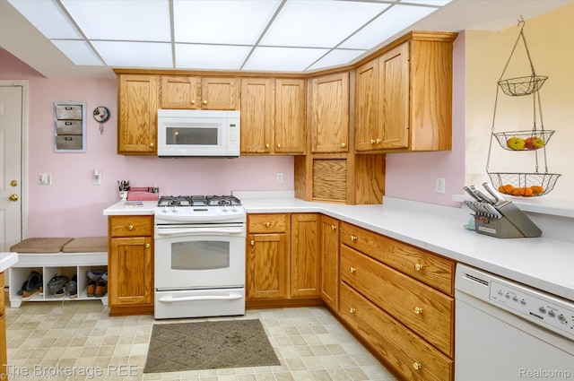 1484 E Baldwin Rd, Grand Blanc, MI 48439 - kitchen with white appliances, light countertops, brown cabinets, and a drop ceiling