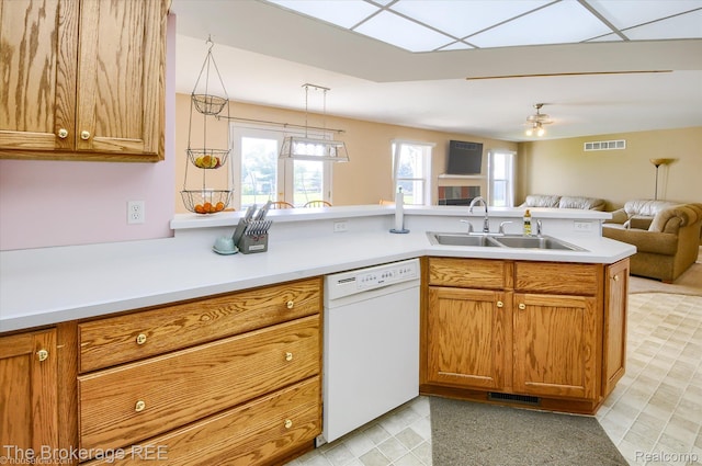 1484 E Baldwin Rd, Grand Blanc, MI 48439 - kitchen with dishwasher, open floor plan, a peninsula, light countertops, and brown cabinets