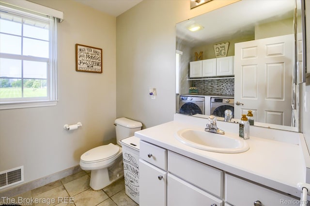 1484 E Baldwin Rd, Grand Blanc, MI 48439 - bathroom featuring washer and dryer, vanity, plenty of natural light, and tile patterned floors