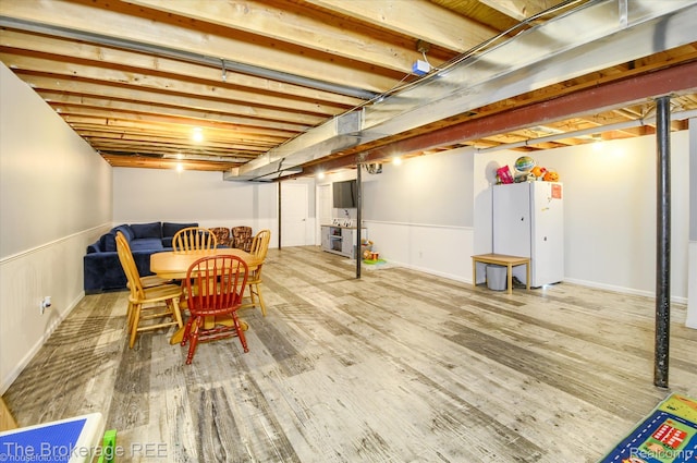 1484 E Baldwin Rd, Grand Blanc, MI 48439 - finished basement featuring wood finished floors and freestanding refrigerator