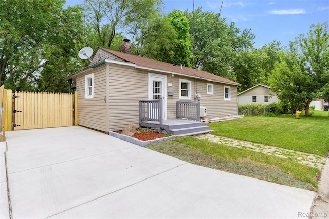 33420 Bentley Ct, Westland, MI 48186 - view of front of property with a chimney, concrete driveway, and a gate