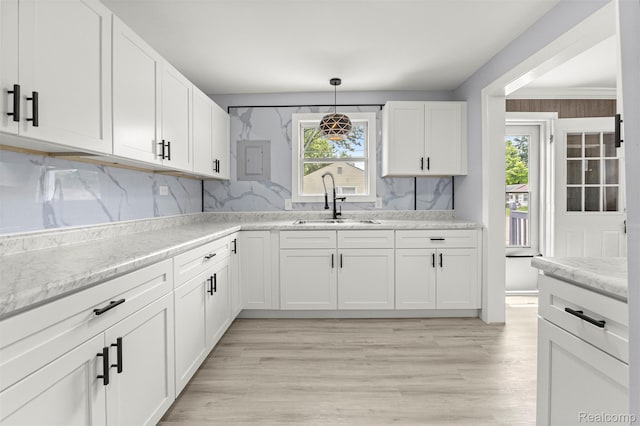 33420 Bentley Ct, Westland, MI 48186 - kitchen featuring tasteful backsplash, white cabinets, and light wood finished floors