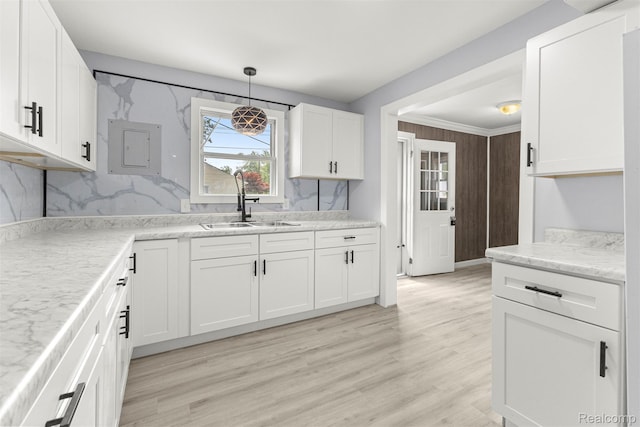 33420 Bentley Ct, Westland, MI 48186 - kitchen featuring white cabinetry, light wood-type flooring, electric panel, decorative light fixtures, and light stone counters