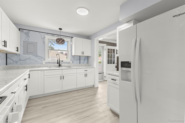 33420 Bentley Ct, Westland, MI 48186 - kitchen featuring white refrigerator with ice dispenser, white cabinets, range, light countertops, and light wood finished floors