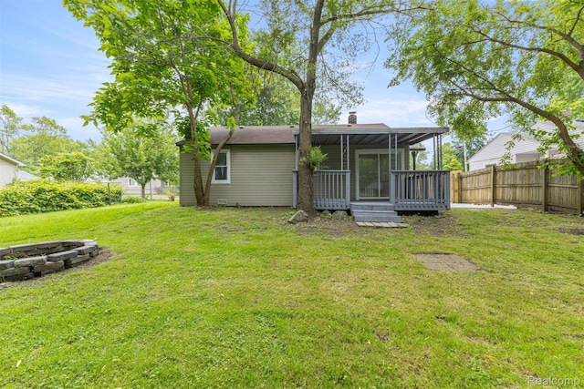 33420 Bentley Ct, Westland, MI 48186 - rear view of house with a sunroom, an outdoor fire pit, and a chimney