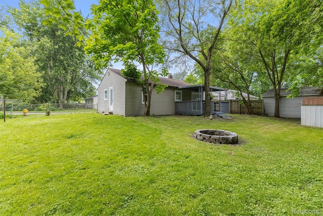 33420 Bentley Ct, Westland, MI 48186 - fenced backyard with a fire pit and a storage unit