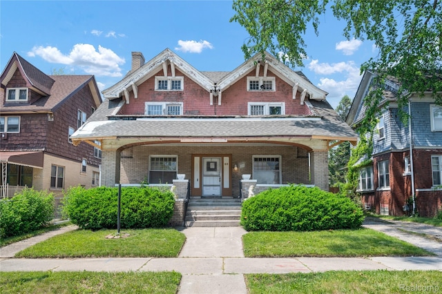 69 Massachusetts St, Highland Park, MI 48203 - view of front facade featuring covered porch, a chimney, and brick siding