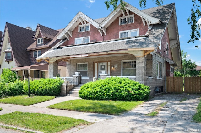 69 Massachusetts St, Highland Park, MI 48203 - view of front of house featuring a porch, brick siding, and a shingled roof