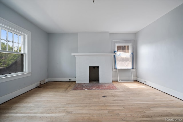 69 Massachusetts St, Highland Park, MI 48203 - unfurnished living room with a fireplace with flush hearth and wood finished floors