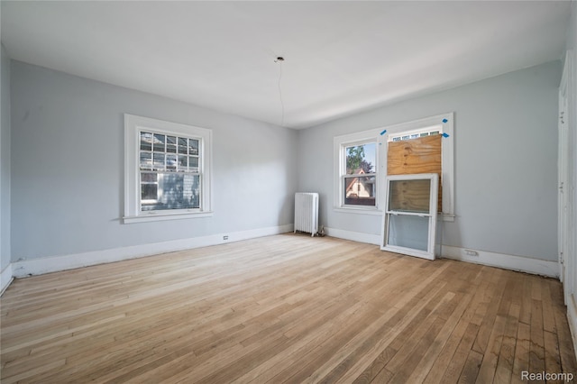 69 Massachusetts St, Highland Park, MI 48203 - unfurnished room featuring radiator and wood-type flooring