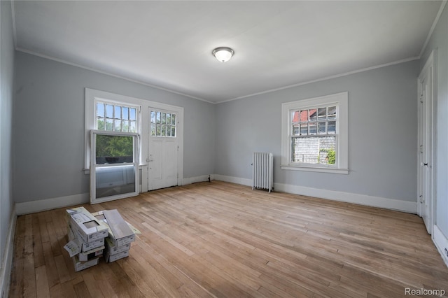 69 Massachusetts St, Highland Park, MI 48203 - spare room featuring radiator heating unit, ornamental molding, plenty of natural light, and hardwood / wood-style floors