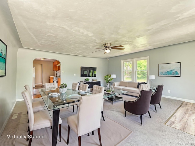 1309 Wood St, Monroe, MI 48161 - dining room featuring arched walkways, ceiling fan, and wood finished floors
