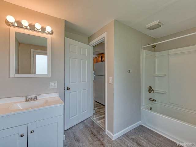 1309 Wood St, Monroe, MI 48161 - full bath featuring wood finished floors, vanity, and shower / washtub combination