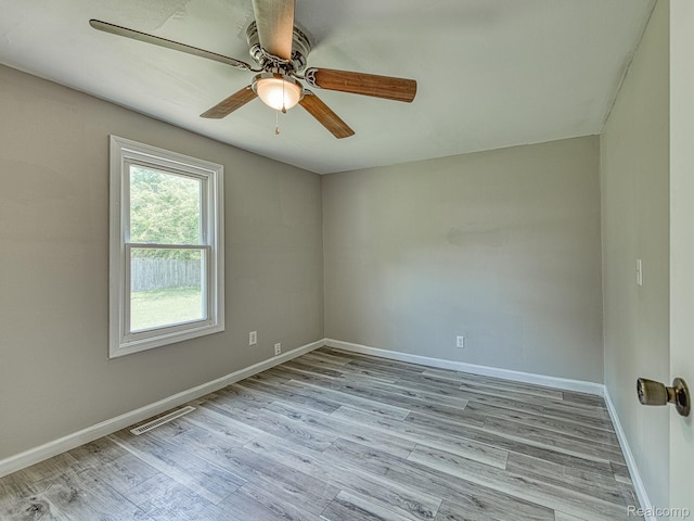 1309 Wood St, Monroe, MI 48161 - empty room with wood finished floors and ceiling fan