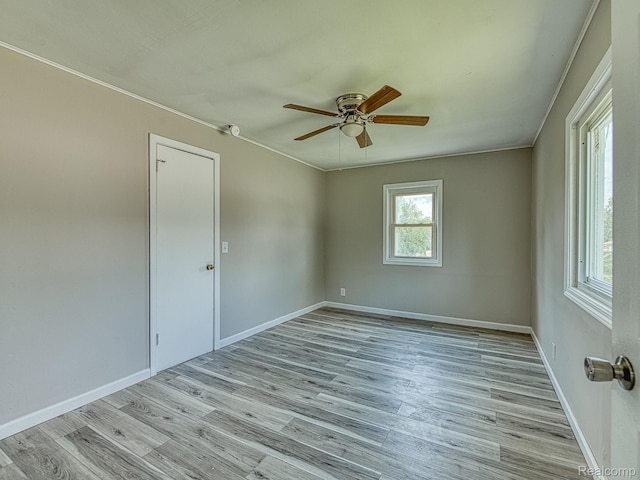 1309 Wood St, Monroe, MI 48161 - spare room featuring wood finished floors, a ceiling fan, and crown molding