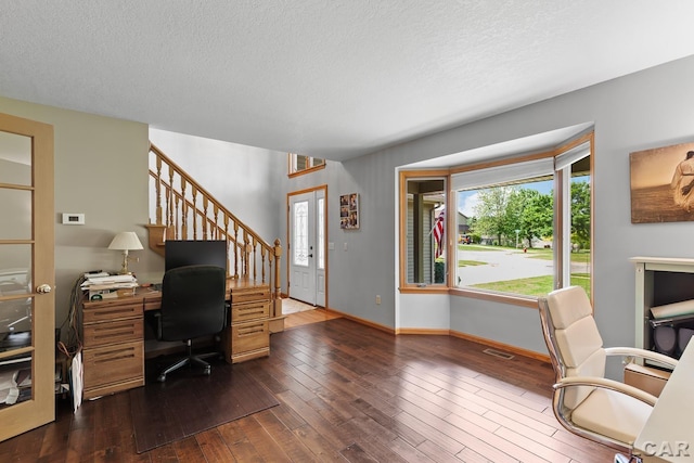 838 Stetson St, Tecumseh, MI 49286 - home office with dark wood-style floors and a textured ceiling