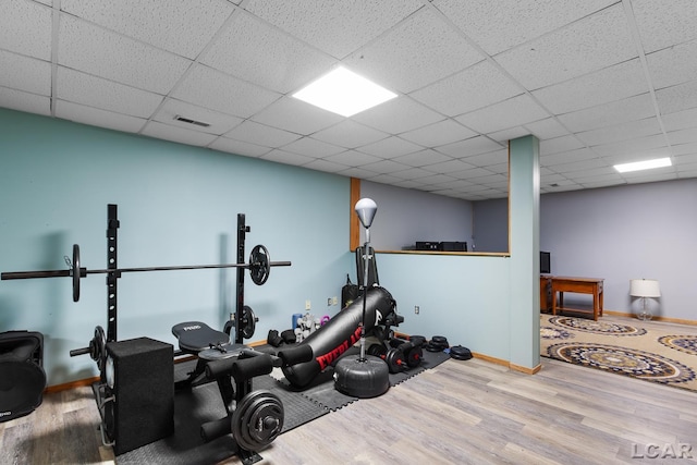 838 Stetson St, Tecumseh, MI 49286 - exercise room featuring wood finished floors and a paneled ceiling