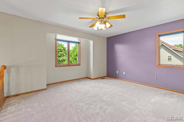 838 Stetson St, Tecumseh, MI 49286 - empty room with light colored carpet and a ceiling fan