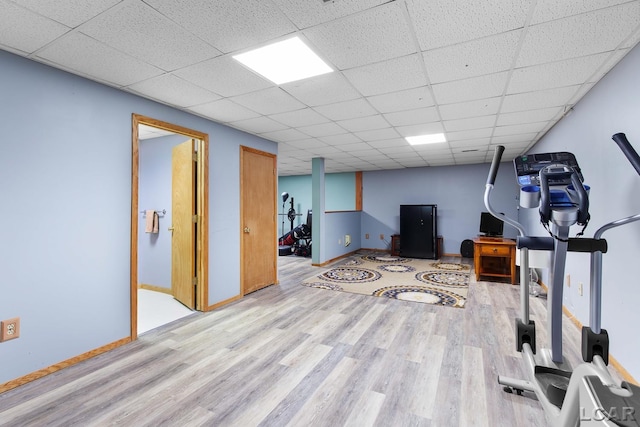 838 Stetson St, Tecumseh, MI 49286 - workout room featuring wood finished floors and a paneled ceiling