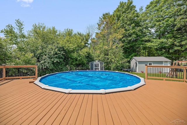 11619 Saddlebrook Cir, Freeland, MI 48623 - outdoor pool featuring a storage shed, a wooden deck, and view of scattered trees