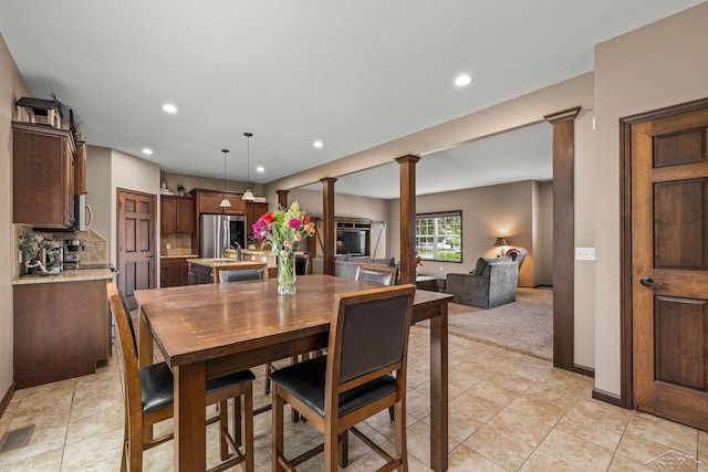 11619 Saddlebrook Cir, Freeland, MI 48623 - dining room featuring decorative columns, recessed lighting, light colored carpet, and light tile patterned floors